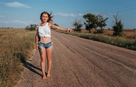 Обои girl road model shorts long hair legs trees field photo