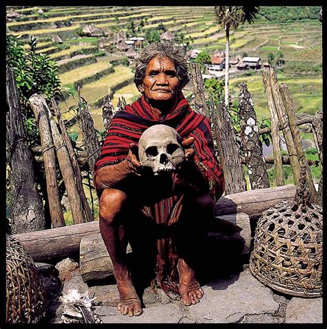ifugao head hunting trophy skull held by an ifugao mombaki shaman in