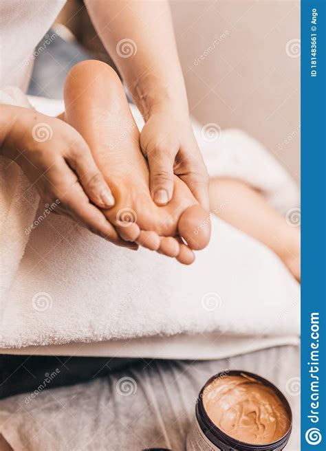 masseur massages lifting the legs with the thumbs from the tips of