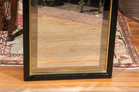 Smoked And Beveled Glass Wall Mirror In A Black And Brass