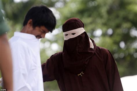 woman is caned in public for having sex outside wedlock in indonesia daily mail online