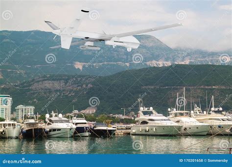 unmanned rc military drone flies  yachts  boats  harbor  mountains stock photo