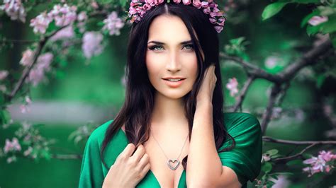 green eyes brunette girl model with wreath and pendant is wearing green