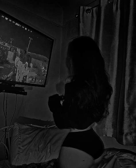 Black And White Photograph Of Woman Watching Tv In Dark Room With
