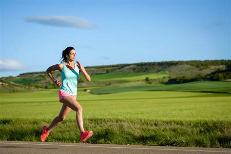 sporty woman running fast  country side road female athlete training outdoor  marathon