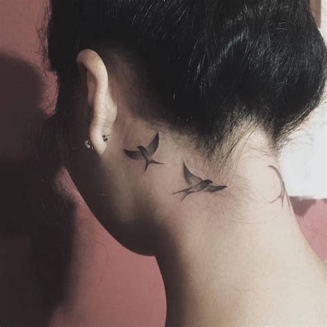 swallow tattoos   left ear