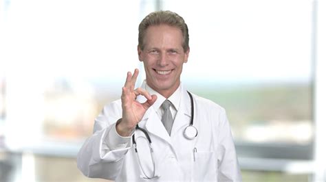 middle aged doctor gesturing  happy male doctor showing  sign