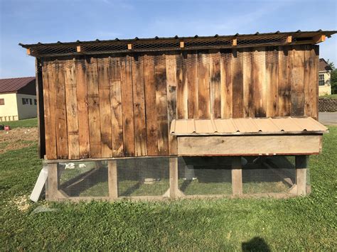 chicken coop built   side   building  wooden slats   sides