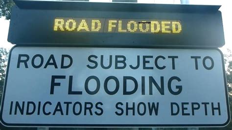 solar flood signs across logan city warn drivers about