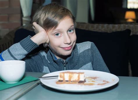 beatiful funny child sitting   restaurant eating cake  smiling