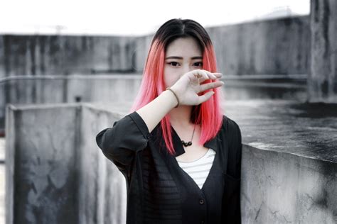 Black And White Asian Woman With Pink Dyed Hair Sticking Out – Picnoi