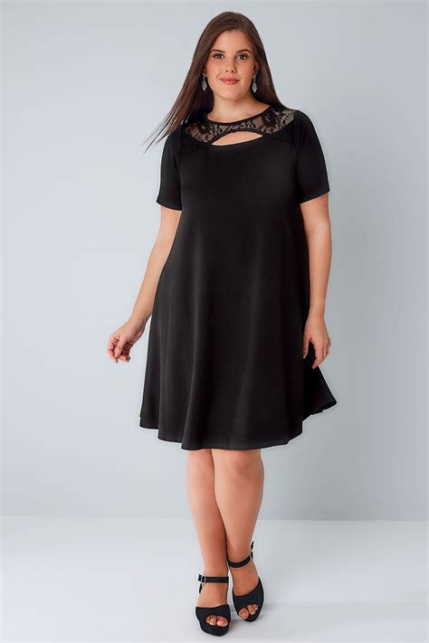 black swing dress with cut out neckline and lace panel plus