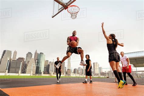 young people playing basketball stock photo dissolve