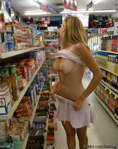 naughty woman flashing her boobs in the local convenience store