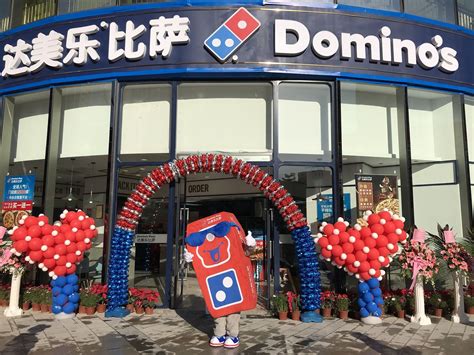 dominos pizza celebrates  opening    international store