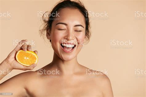 beauty smiling woman with radiant face skin and orange portrait stock