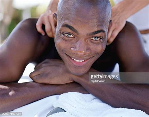 Mixed Race Masseuse Standing At Massage Table In Spa Photos And Premium