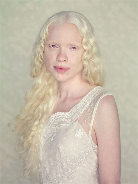 A Woman With Long Blonde Hair Wearing A White Dress