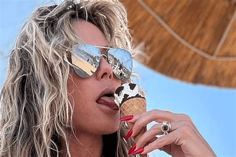 as heidi klum enjoys an ice cream cone while wearing a tiny white