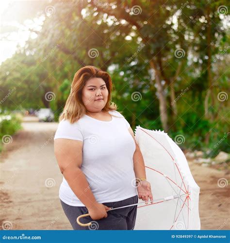 Asian Beautiful Fat Woman With Umbrella In The Garden Stock Image