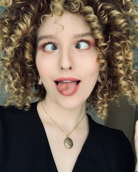 curly haired girl showing off her tongue scrolller