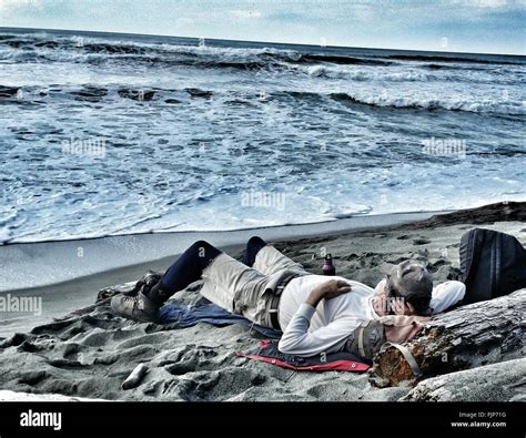 man sleeping  beach high resolution stock photography  images alamy