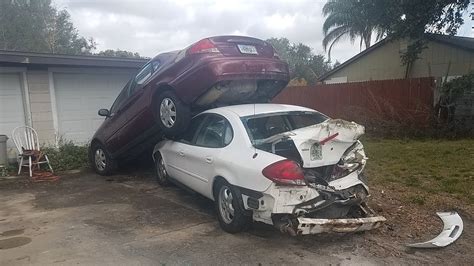 hit  run crash leaves smashed cars stacked  driveway