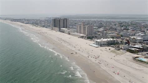 stock footage aerial video  beach goers  beachfront condo