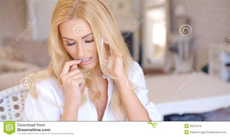Woman Calling Through Phone While Biting Her Nail Stock