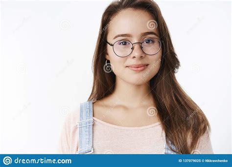 Close Up Shot Of Friendly Happy Dreamy Young Woman In Glasses Smiling