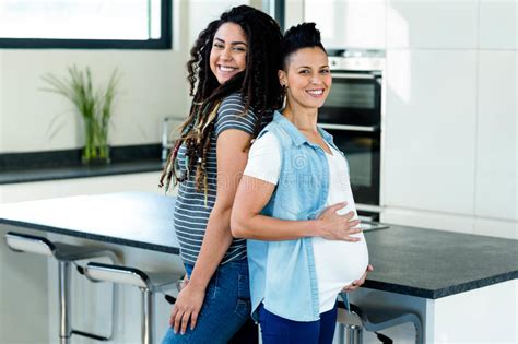 pregnant lesbian couple standing back to back stock image image of happy bonding 66973433