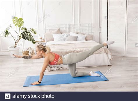 young athletic attractive woman practicing yoga  donkey kick