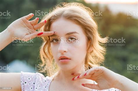 Closeup Portrait Of A Beautiful Shorthaired Blonde At Sunset Stock