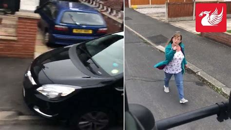 shocking moment woman driver mounts pavement and confronts