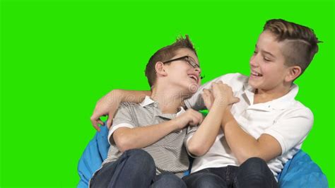 two brothers are fooling around at green background stock video video