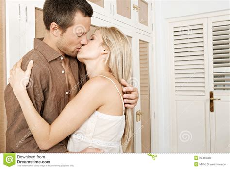 Couple Hugging And Kissing In Bedroom Royalty Free Stock