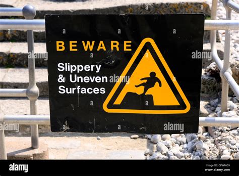 warning sign beware slippery uneven surfaces stock photo alamy