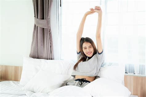 Asian Woman Stretching In Bed After Wake Up Photograph By Anek