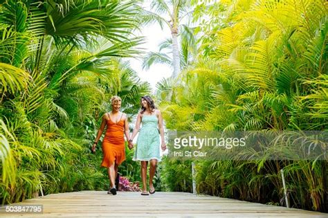 Lesbian Couple Holding Hands On Tropical Walkway Photo Getty Images