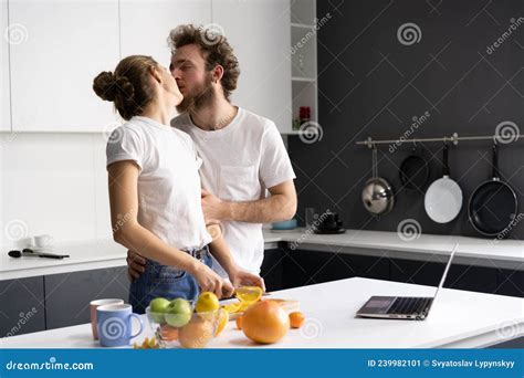 In Love Young Couple Kissing While Preparing Food At Kitchen Husband