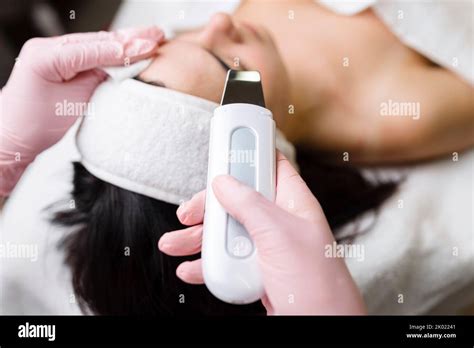 facial cleansing with ultrasound scrubber woman receiving ultrasound