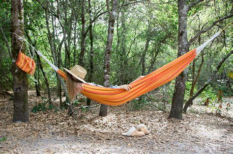Person Taking A Nap In A Hammock In The Woods By Stocksy Contributor