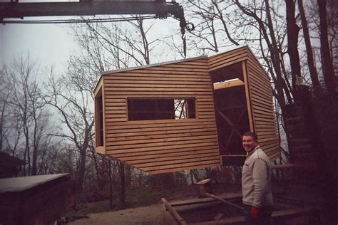 tiny wooden cabin  stilts   cozy escape   trees