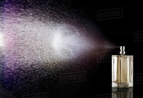 perfume spraying  bottle stock photo dissolve