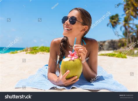 Pretty Blonde In White Bikini Drinking Coconut Drink On The Beach Stock