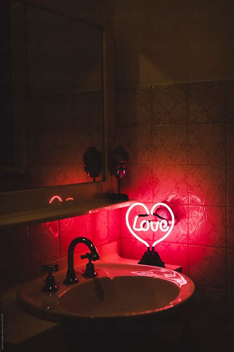 love neon sign inside a toilet by stocksy contributor mauro grigollo