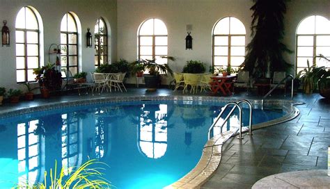 Retro House Indoor Pool Design With Curves Shape And Rustic Floor Tile