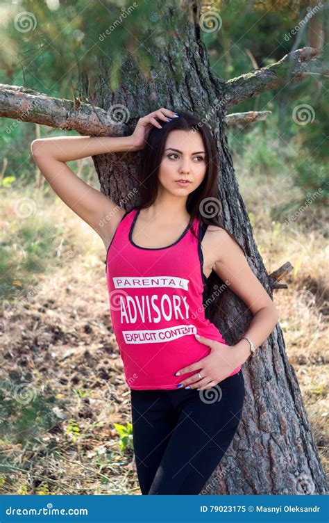 Young Beautiful Brunette Model Posing In The Sports Image Of The Park