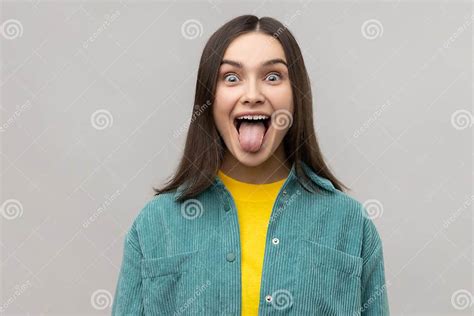 Dark Haired Woman Sticking Out Tongue And Looking At Camera Teasing