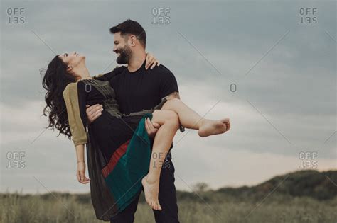 man carrying woman stock photo offset